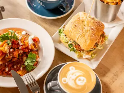 The best cafes in Toronto | A latte, sandwich and side dish at Snakes & Lattes