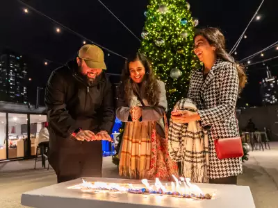 Christmas bars and markets in Toronto | Guests warming their hands by the fire at Stackt Holiday Hills