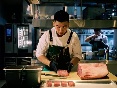 Best new restaurants Toronto | A chef prepares meat at Akin restaurant in Toronto