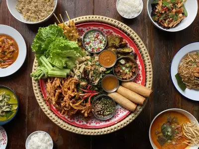 TIFF celebrity hotspots | A spread of food, including spring rolls, vegetables and more at PAI Toronto