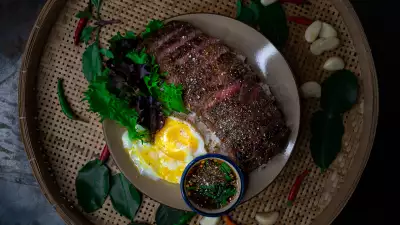 The best new restaurants in Toronto | Striploin steak on rice with jim jaew served with onsen egg at Maya Bay