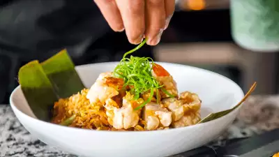 Toronto home cooks and their online food businesses | Wesley Altuna garnishing a dish from Bawang