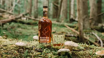 Bearface Matsutake whisky and a glass in the forest