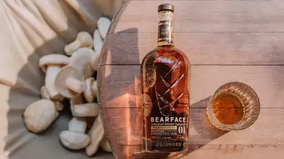 Bearface Matsutake whisky on a table next to mushrooms