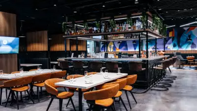 Tables in front of the bar at the Aspire | Air Canada Café at Billy Bishop Toronto City Airport