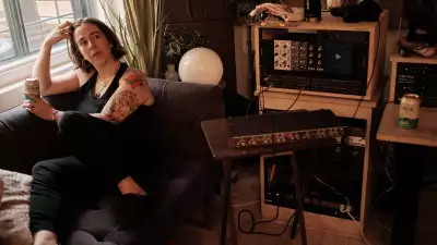 Serena Ryder sitting in her home studio with a can of Libra non-alcoholic beer