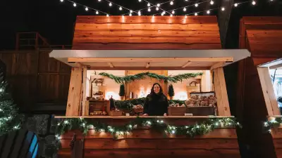 Elora Christmas Market | A woman peeks out of a chalet at the Elora Christmas Market