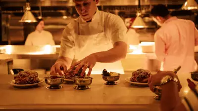 Linny's | Chef David Schwartz plates challah bread at the chef's pass at Linny's