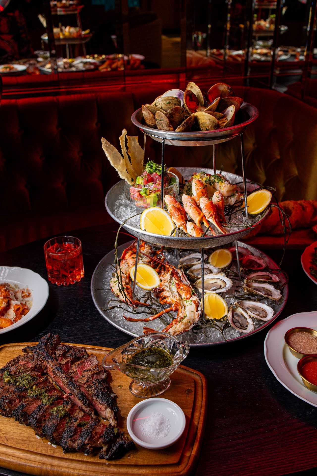 A seafood tower and a steak at Maxime's restaurant in Toronto A seafood tower and a steak at Maxime's restaurant in Toronto