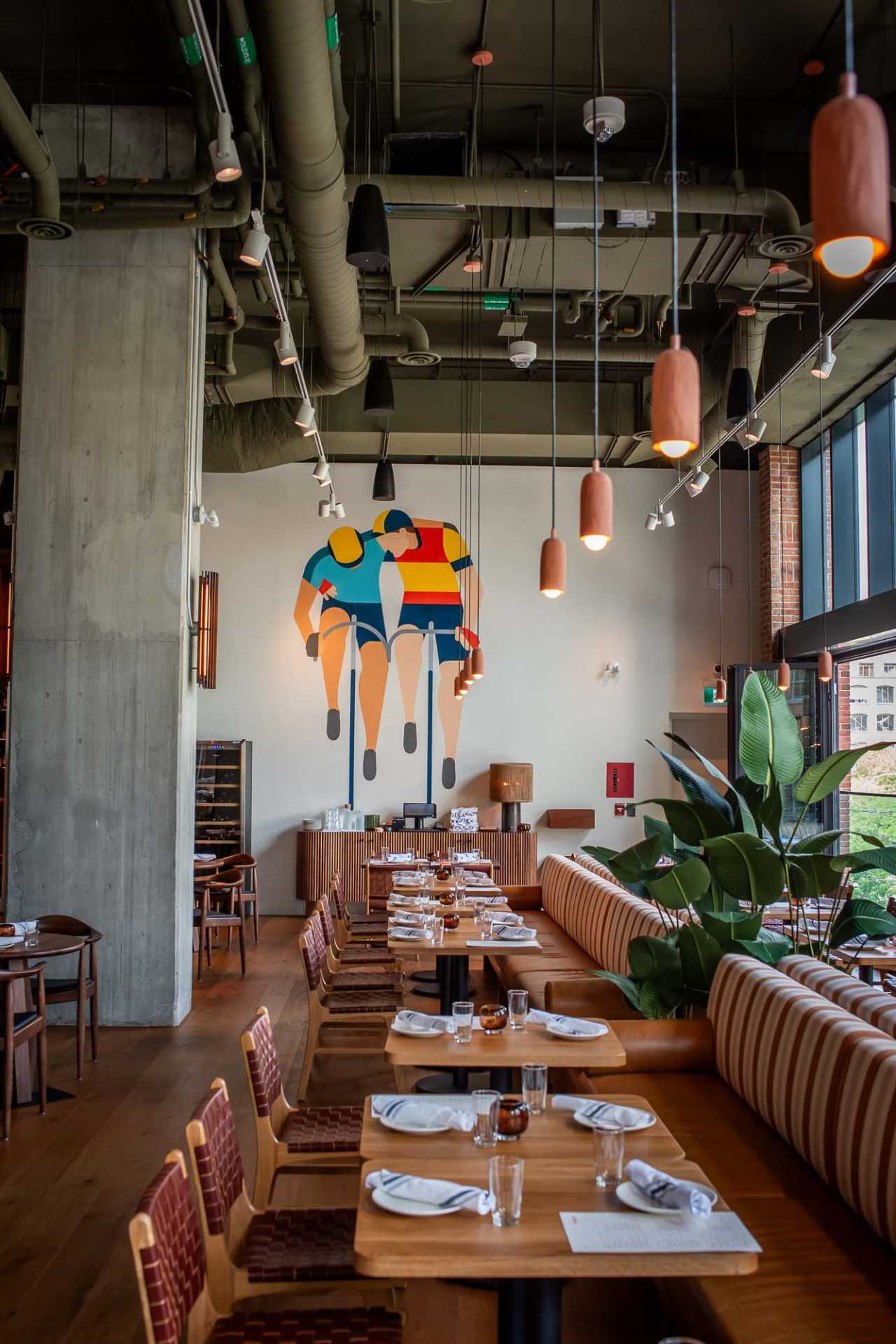 Best new Toronto restaurants | A mural of cyclists inside Bridgette Bar Toronto