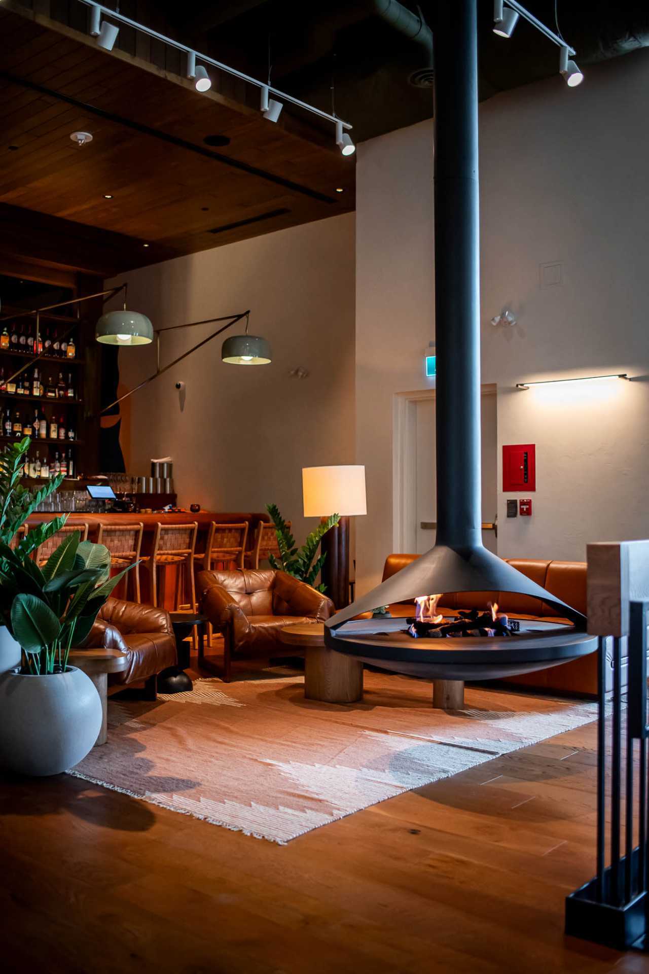 Best new Toronto restaurants | A fireplace with seating inside Bridgette Bar Toronto