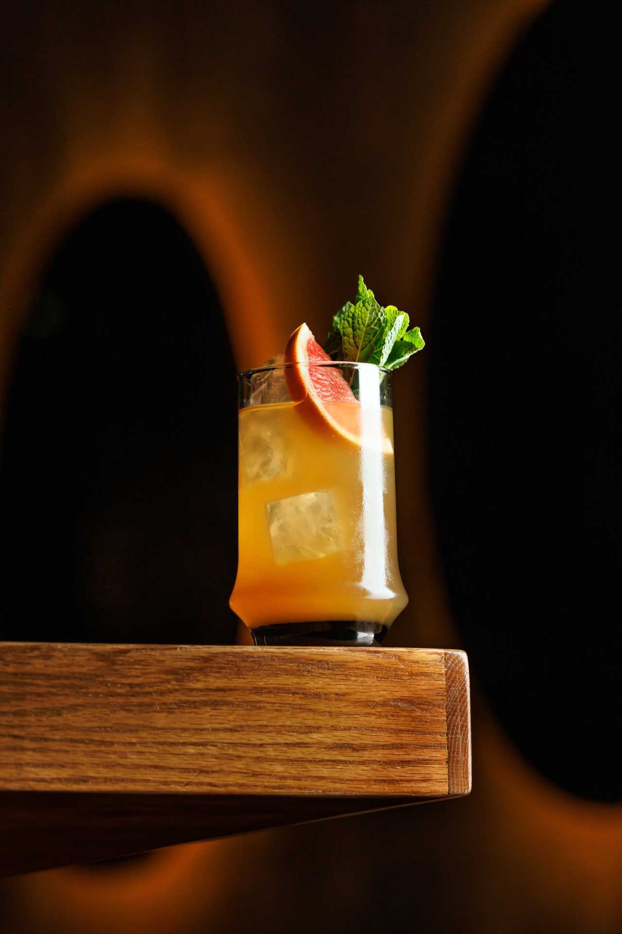 The best bars in Toronto | A bright orange cocktail at Cry Baby Gallery