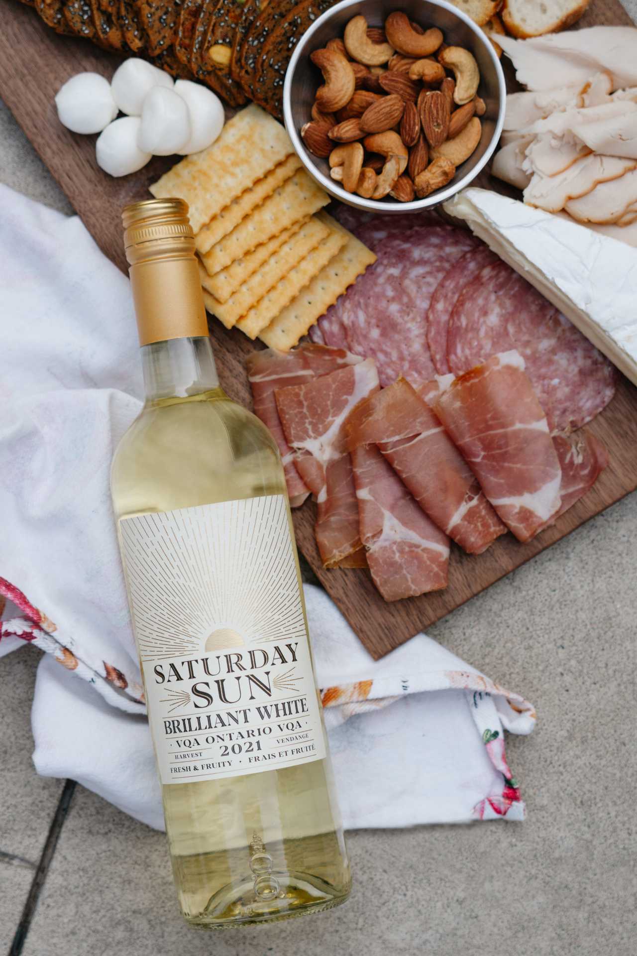 Saturday Sun Brilliant White Harvest VQA with a charcuterie board