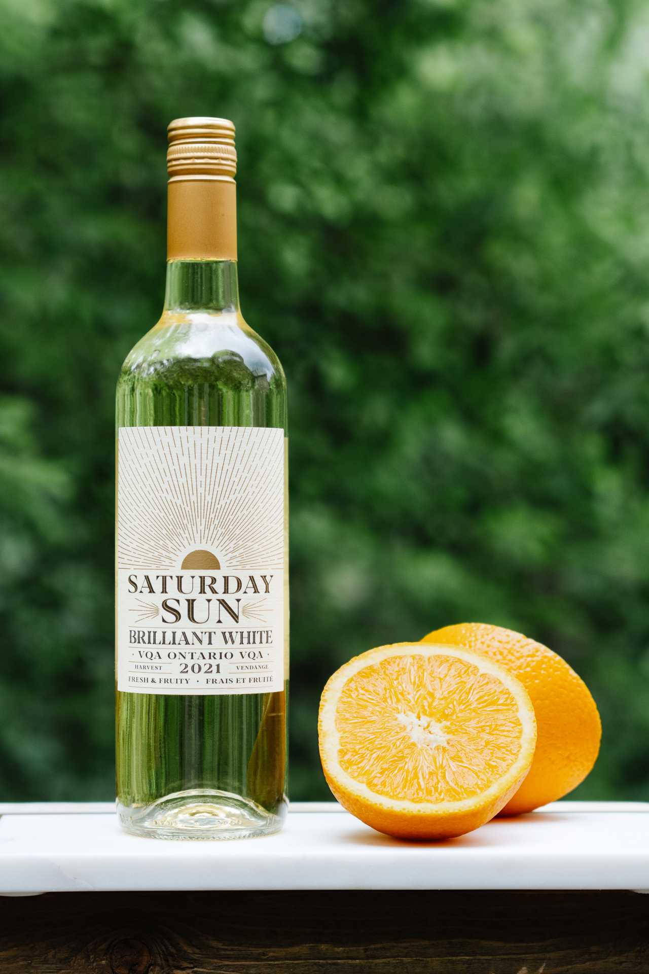 A bottle of Saturday Sun Brilliant White Harvest VQA with an orange