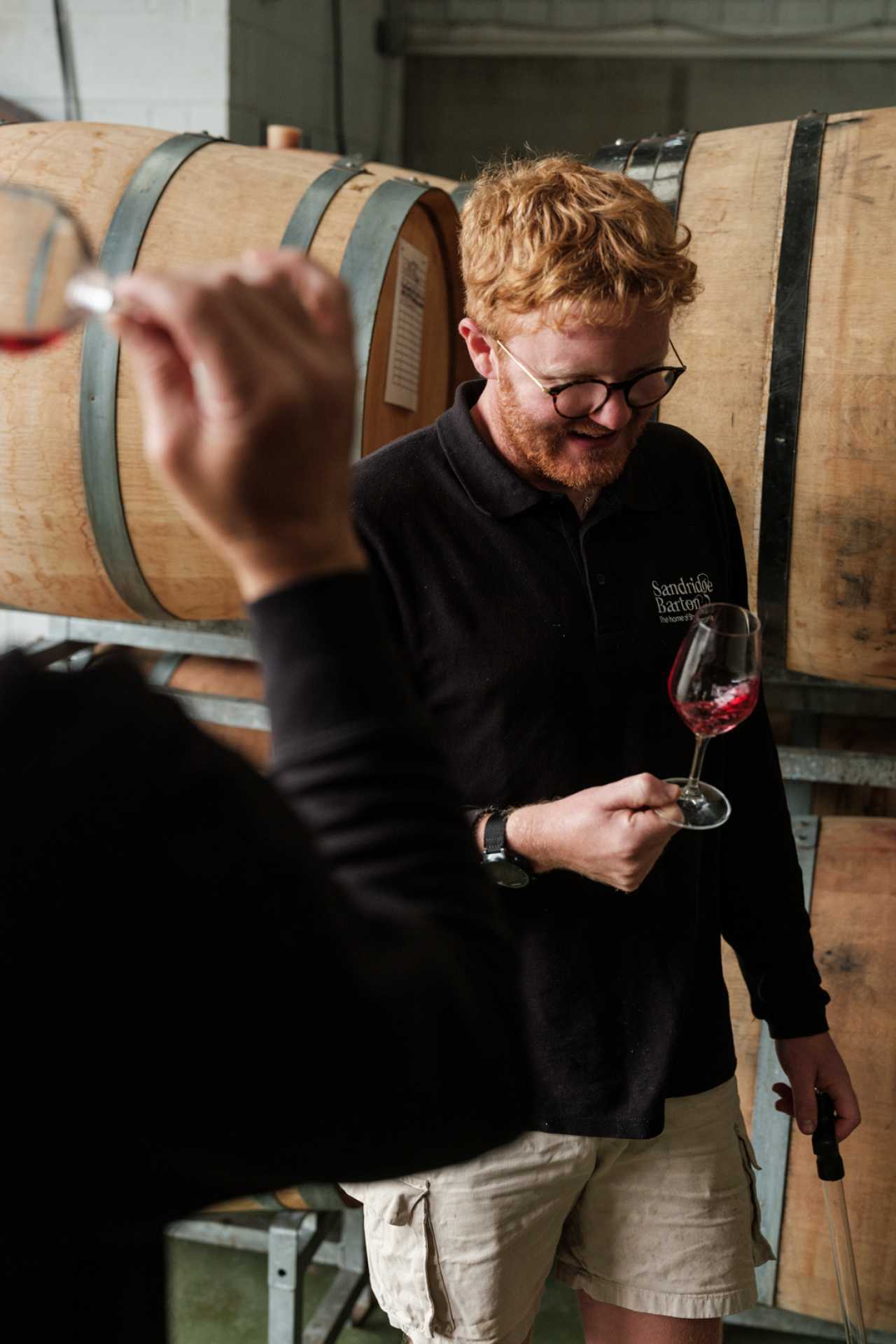 Inside England&rsquo;s evolving wine regions | A guides swirls a glass at a tasting at Sandridge Barton
