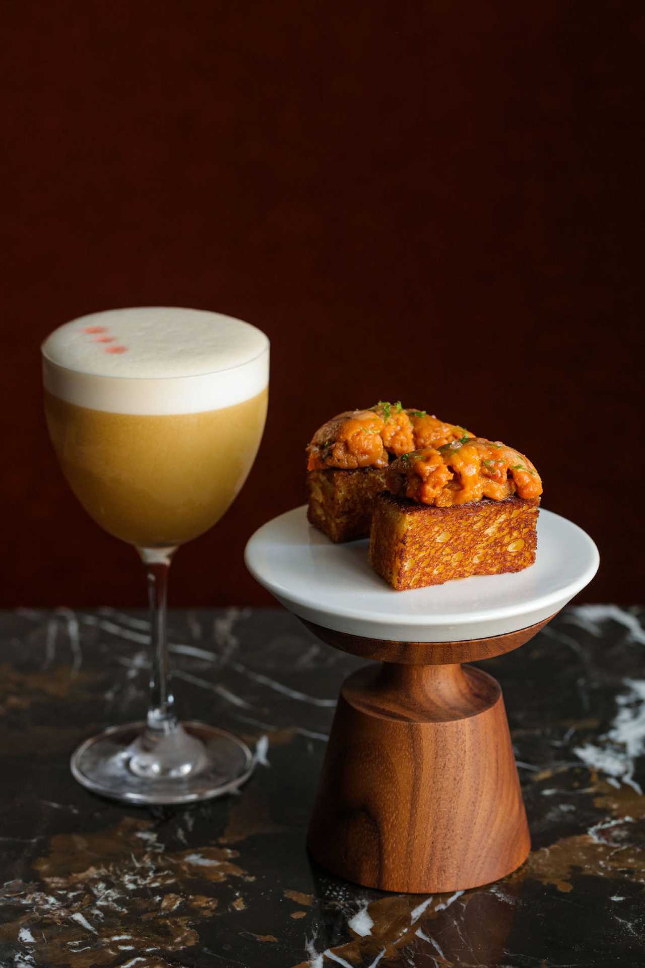 The best bars in Toronto | A cocktail and a toast and uni plate at Bar Banane