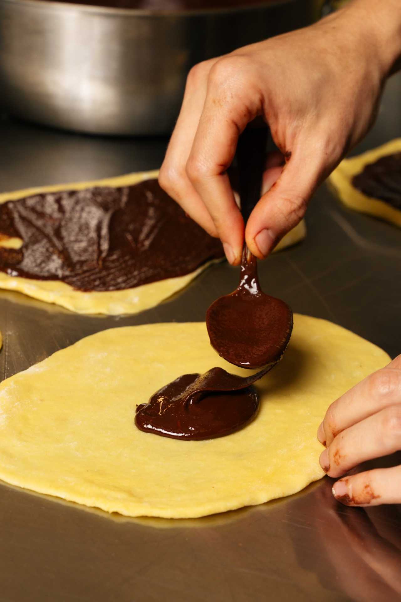 Farm-to-table dining in Qu&eacute;bec: A hand spoons chocolate onto a crepe at Chez Greenberg
