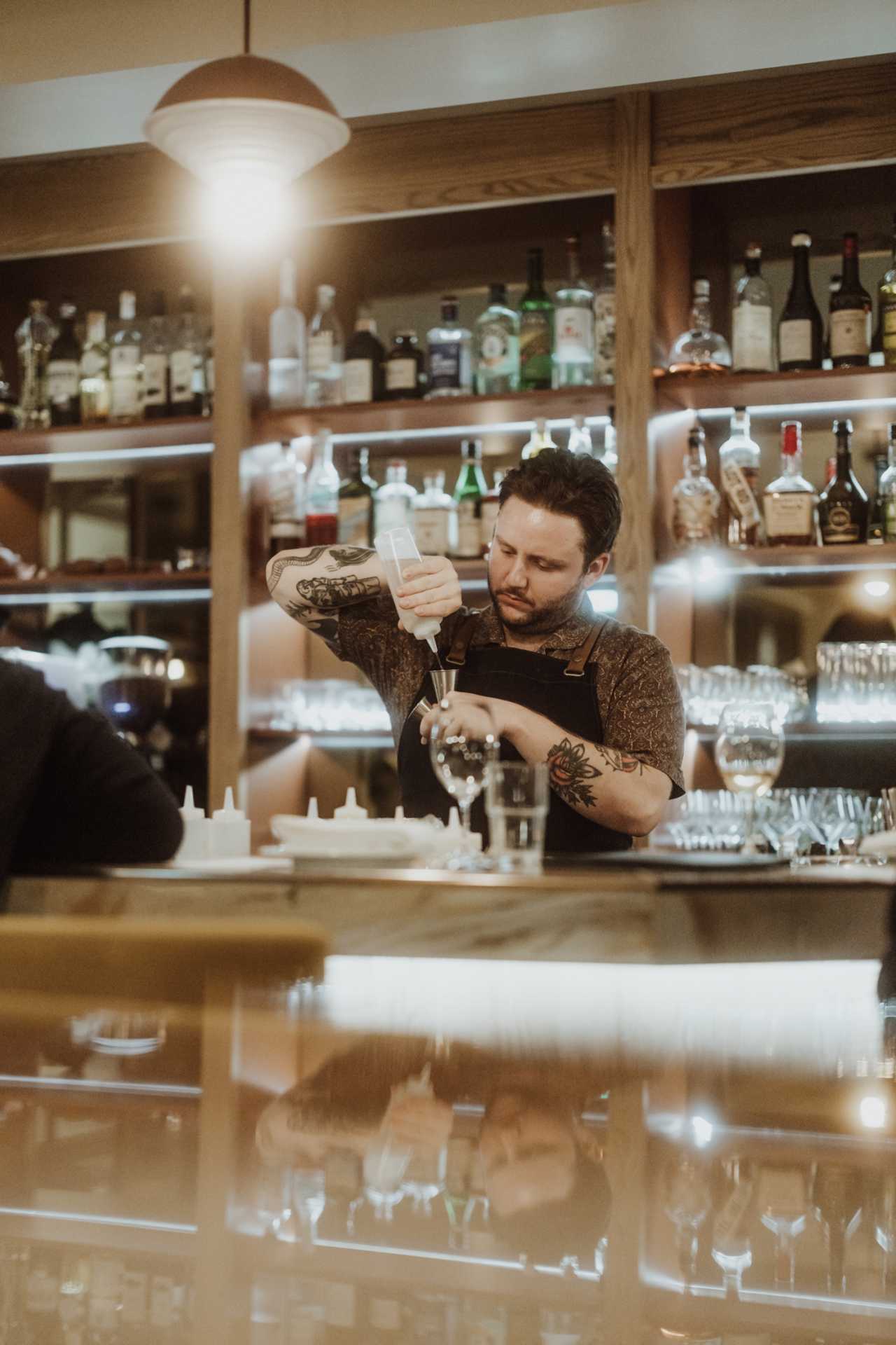 Farm-to-table dining in Qu&eacute;bec: A bartender pours a cocktail at Melba in Quebec City