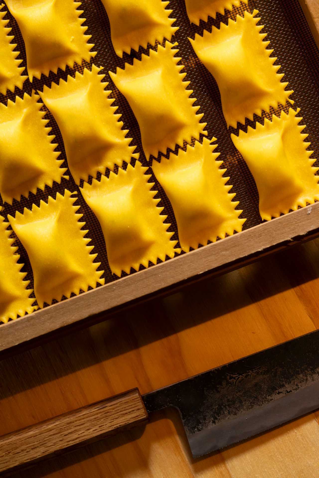 Pasta Privato Toronto | Yellow handmade ravioli sits ready to eat at Pasta Privato in Toronto