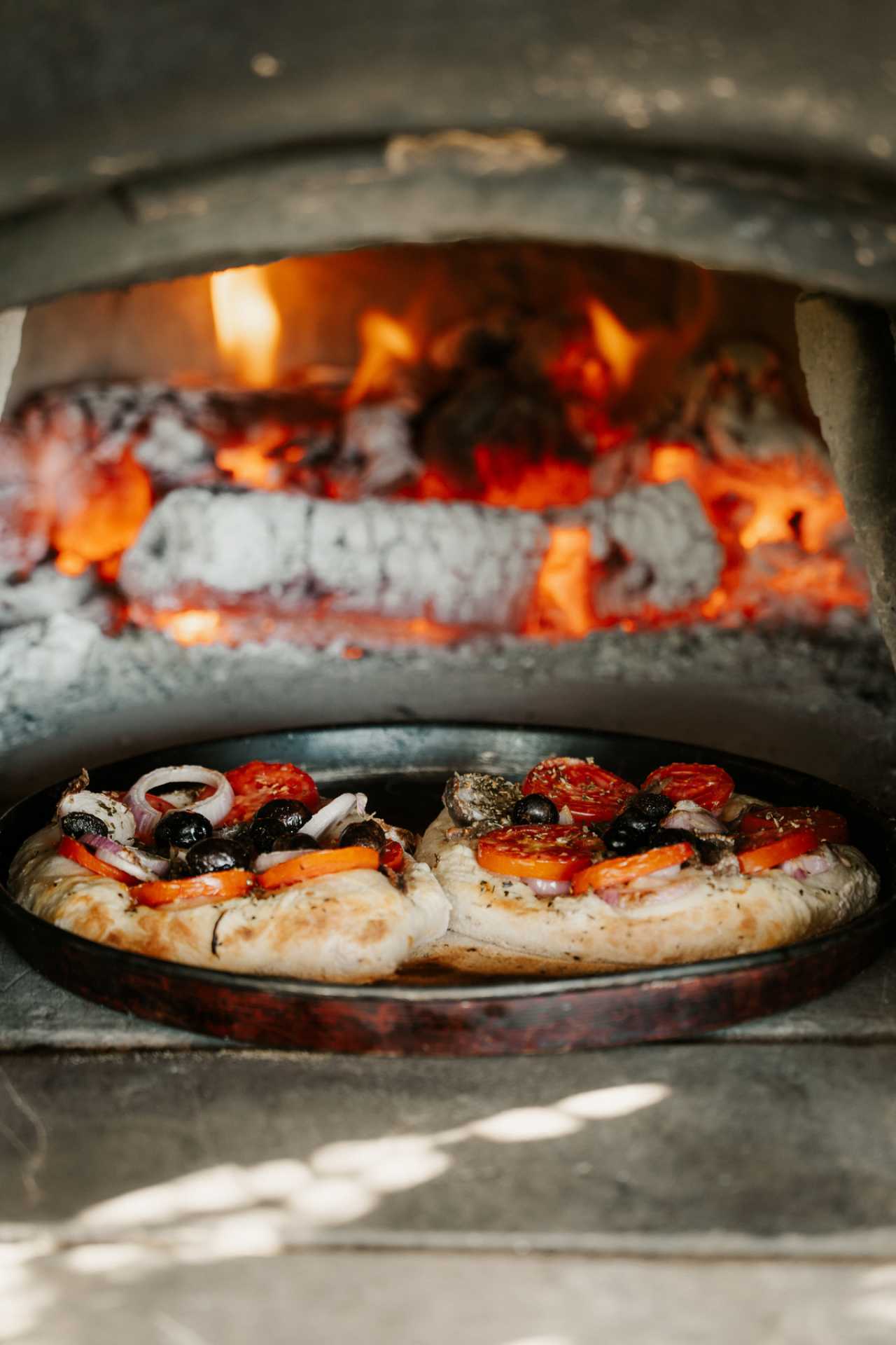 Malta | A pizza cooks in a wood-fired oven