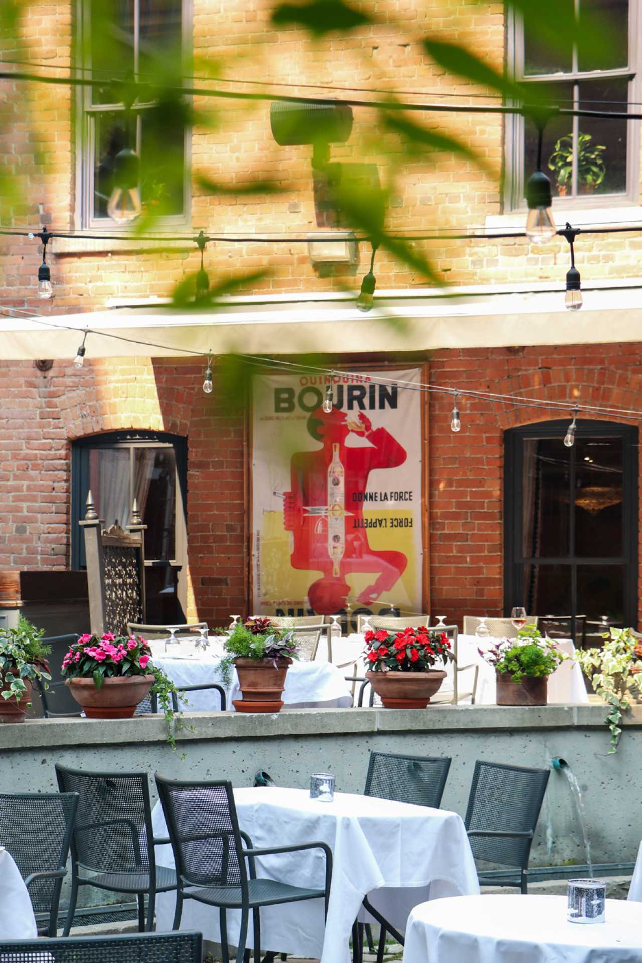 George Restaurant | String lights hang above a retro print in George Restaurant's courtyard patio
