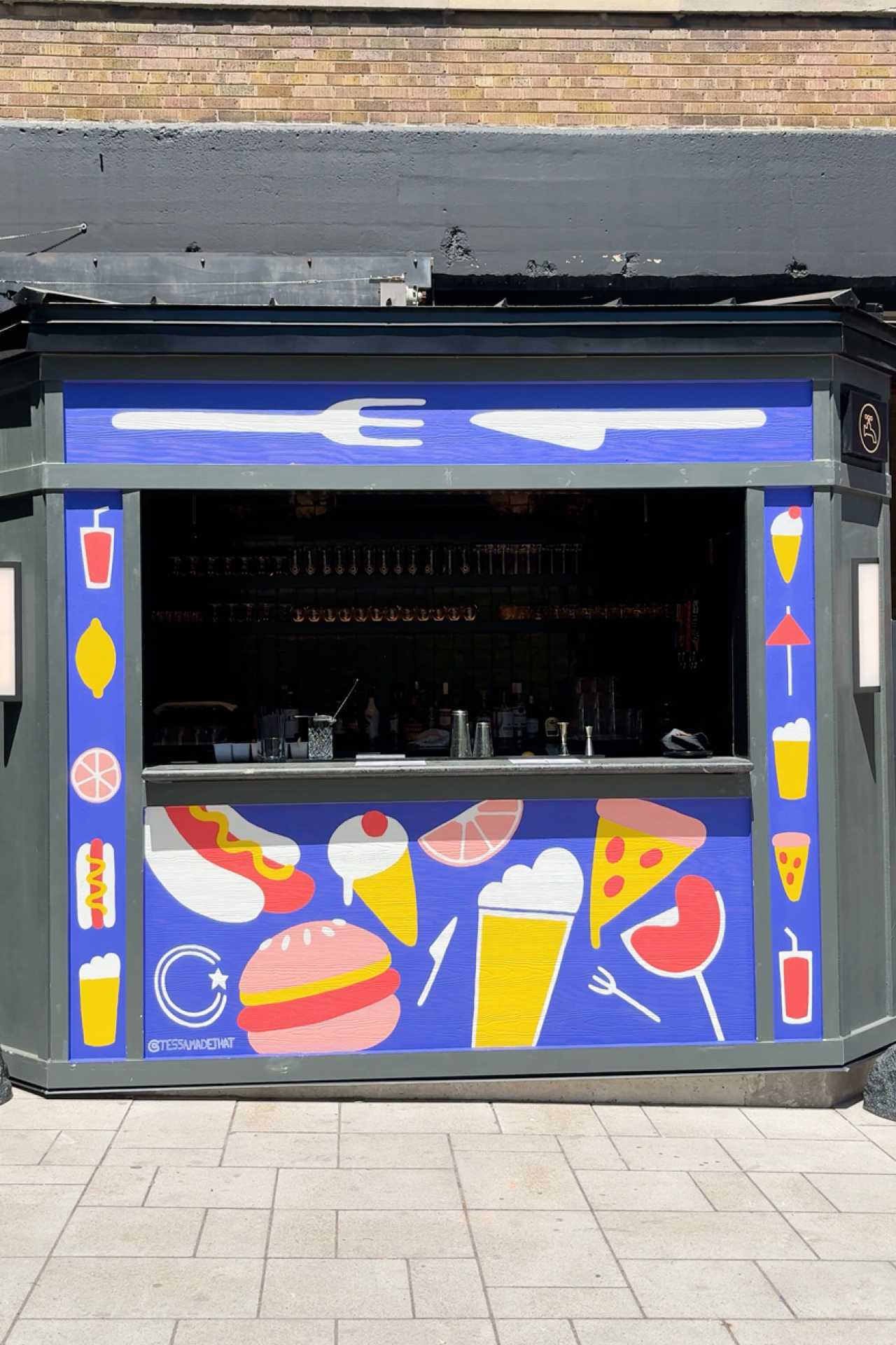 Best patios in Toronto | A mural and bar on the patio at Waterworks Food Hall