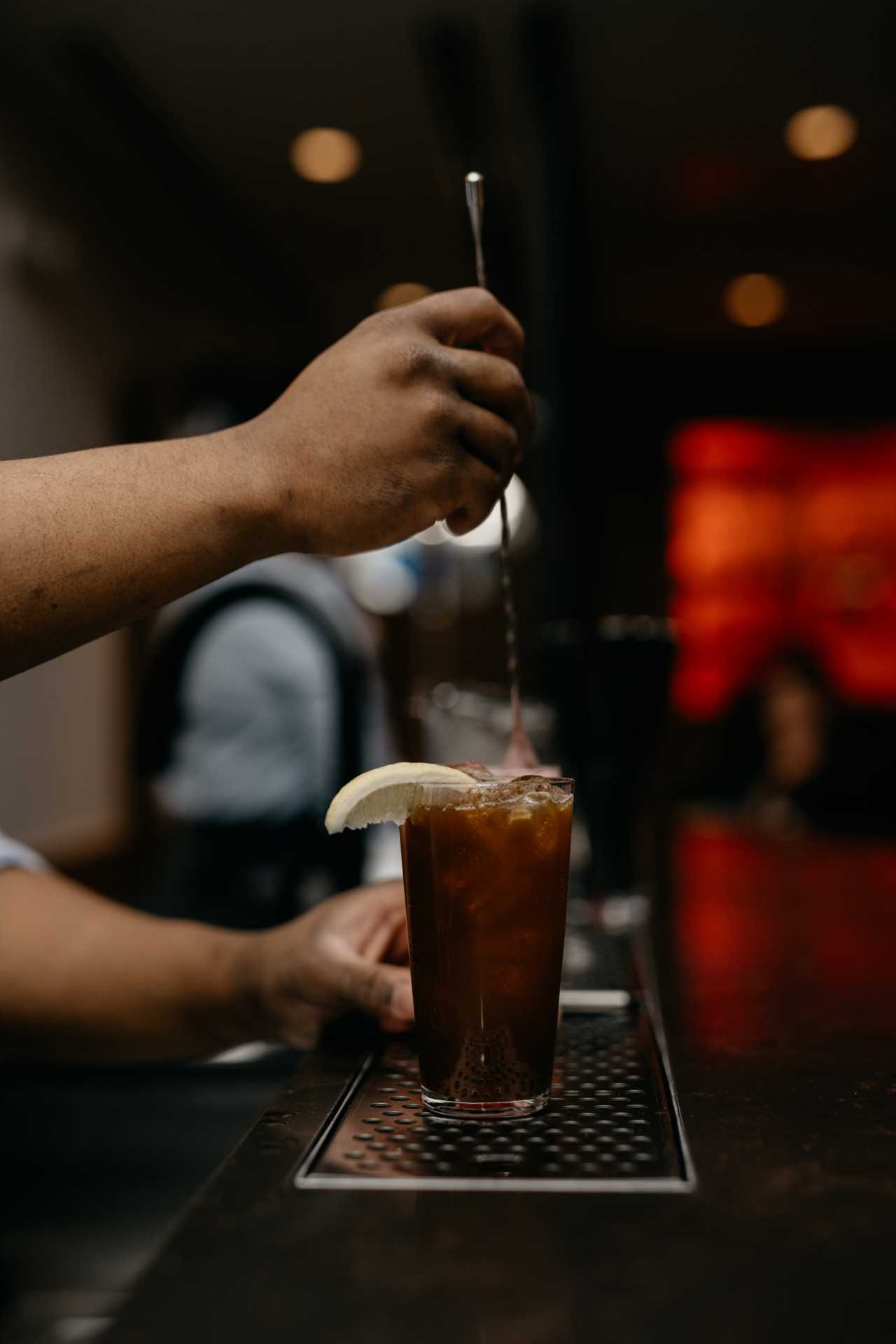 Takja BBQ | A bartender stirs a cocktail at Takja BBQ