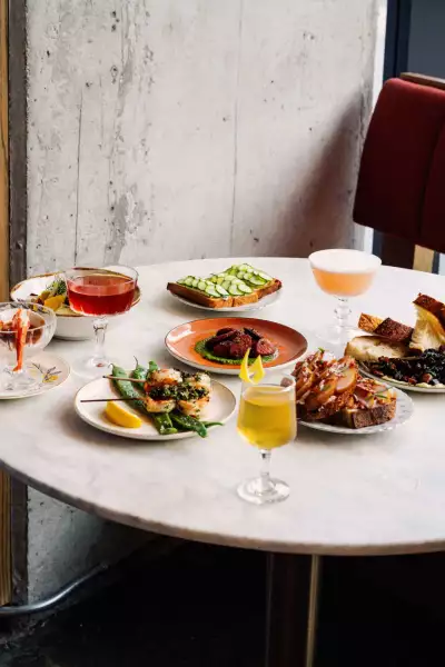 A spread of food on a table in the corner at Lisbon Hotel in Corktown