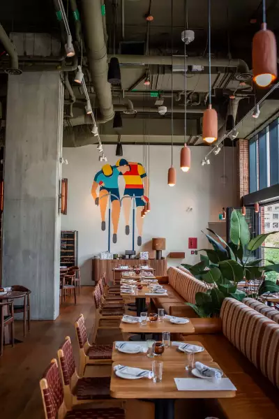 Best new Toronto restaurants | A mural of cyclists inside Bridgette Bar Toronto