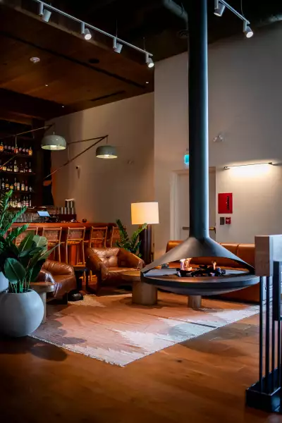 Best new Toronto restaurants | A fireplace with seating inside Bridgette Bar Toronto