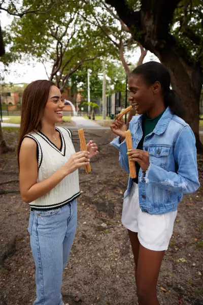 Two girls eating Subway Canada Footlong Churros