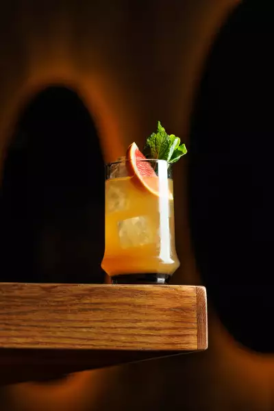 The best bars in Toronto | A bright orange cocktail at Cry Baby Gallery