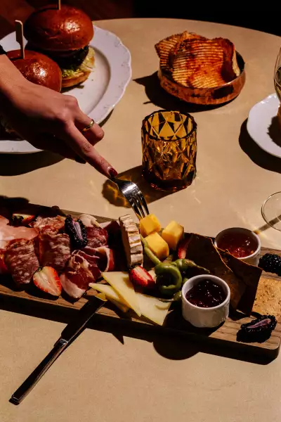 A charcuterie board, sliders and chips inside Mercer Lounge in Le Germain Hotel Toronto Mercer