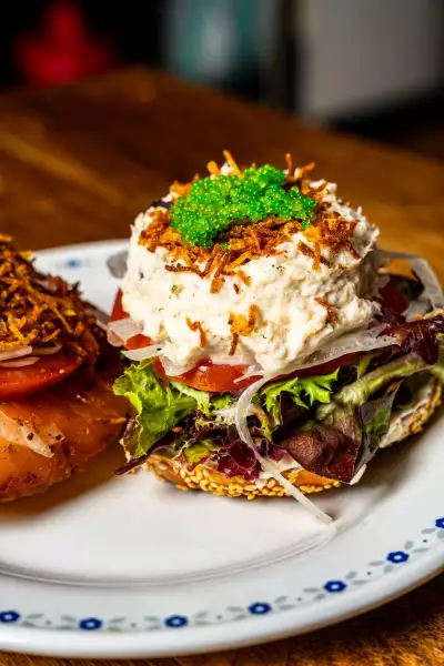 Farm-to-table dining in Qu&eacute;bec: An open-face bagel stacked with cream cheese, capers and smoked salmon at Chez Greenberg