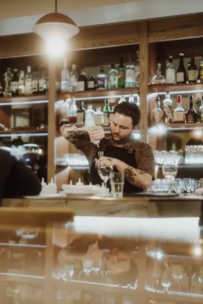 Farm-to-table dining in Qu&eacute;bec: A bartender pours a cocktail at Melba in Quebec City