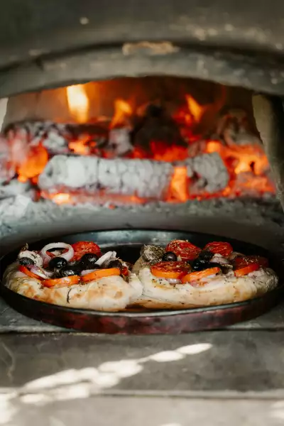 Malta | A pizza cooks in a wood-fired oven