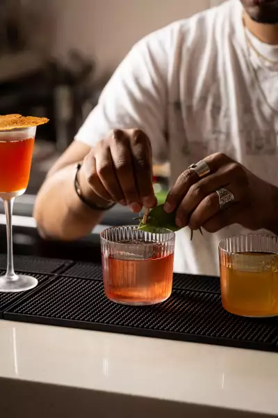 Best restaurants in Toronto | A bartender making a cocktail at Ricky + Olivia