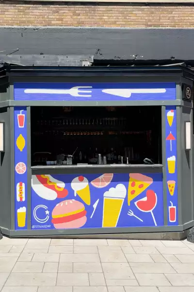 Best patios in Toronto | A mural and bar on the patio at Waterworks Food Hall
