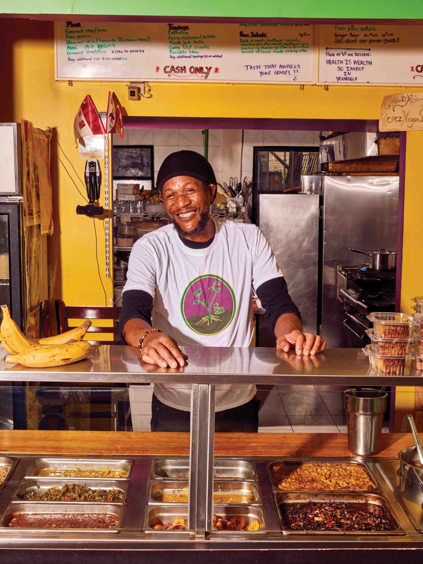 Vegan food in Toronto | Chef Pong standing behind the counter at V's Caribbean Restaurant Vegan food in Toronto | Chef Pong standing behind the counter at V's Caribbean Restaurant