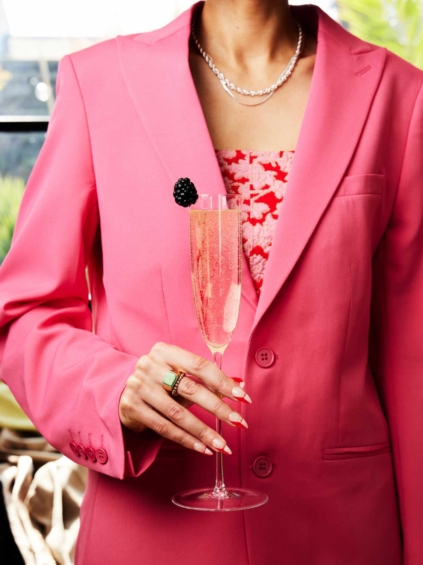 A lady in pink holds a cocktail made with St-Germain Elderflower Liqueur A lady in pink holds a cocktail made with St-Germain Elderflower Liqueur