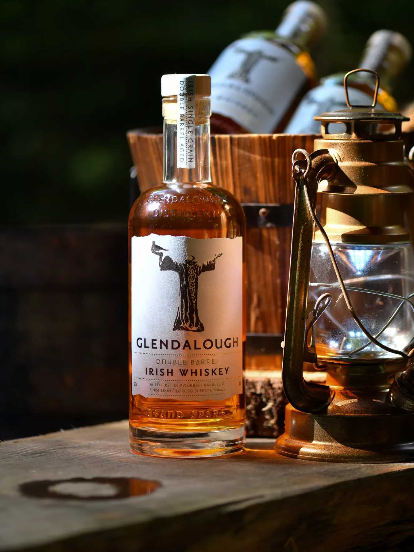 A bottle of Glendalough Double Barrel Irish Whiskey with a lantern A bottle of Glendalough Double Barrel Irish Whiskey with a lantern