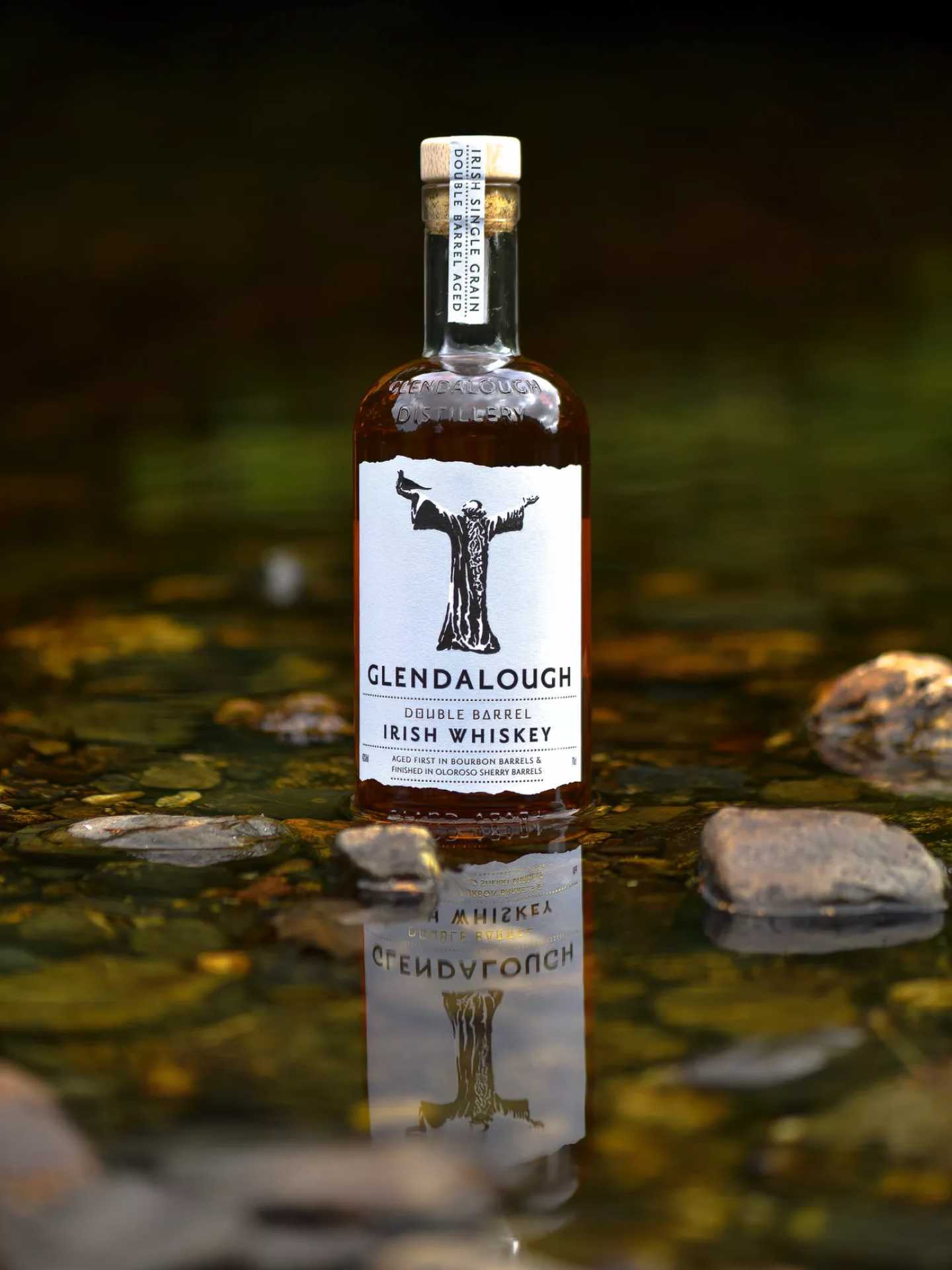 A bottle of Glendalough Double Barrel Irish Whiskey in a pond A bottle of Glendalough Double Barrel Irish Whiskey in a pond