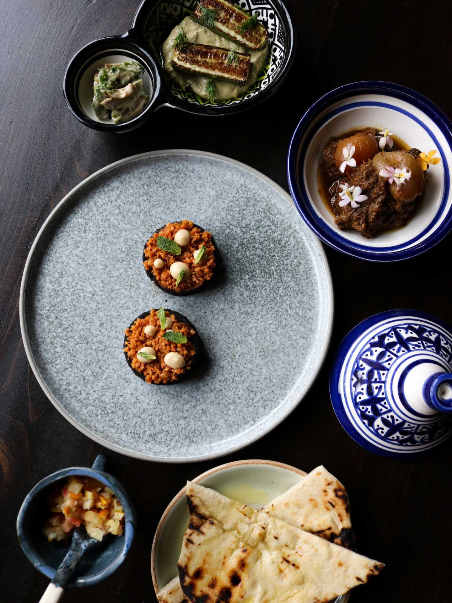 An overhead shot of tasting menu dishes at Azura