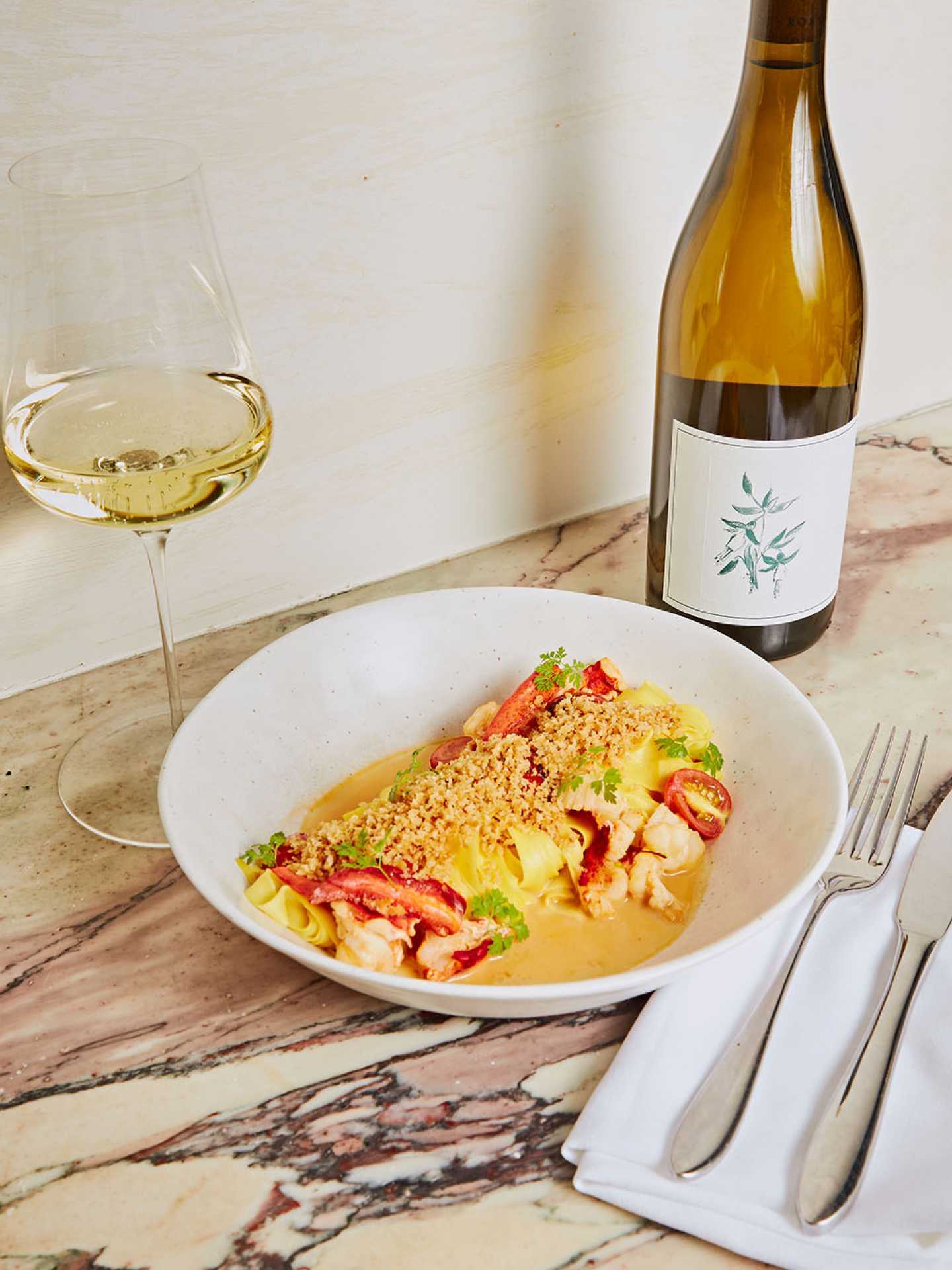 A pasta dish and wine at Henry's restaurant Toronto