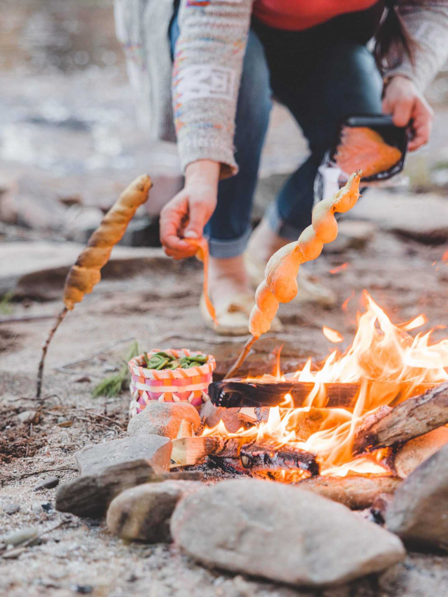 Indigenous food experiences in Canada | Jenna White cooks bannock over the fire Indigenous food experiences in Canada | Jenna White cooks bannock over the fire