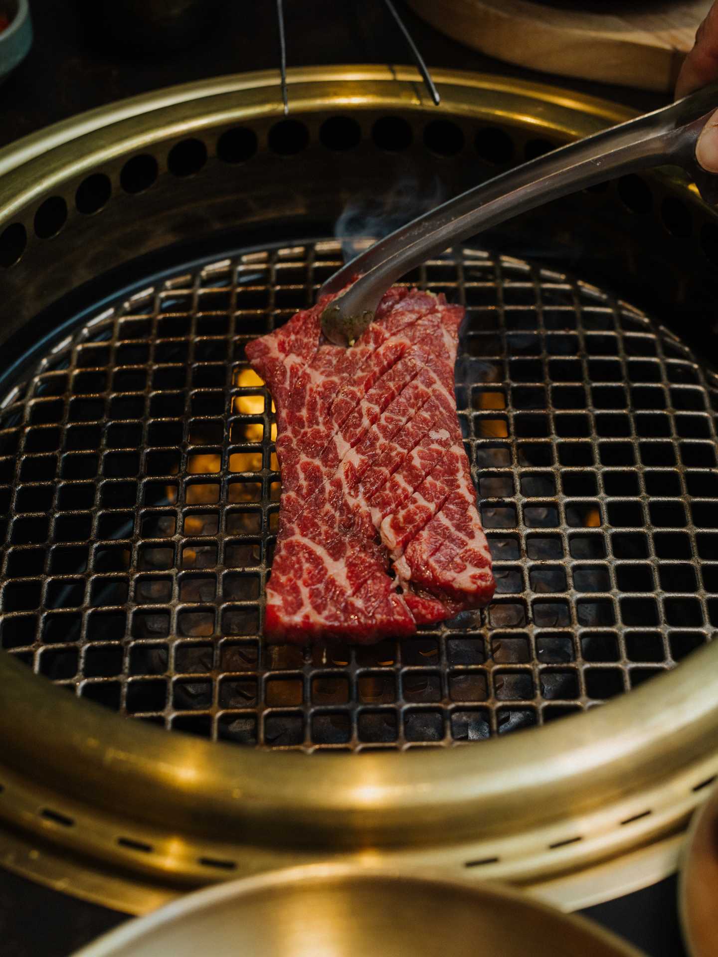 Best new Toronto restaurants | Raw meat on the grill at Takja BBQ House