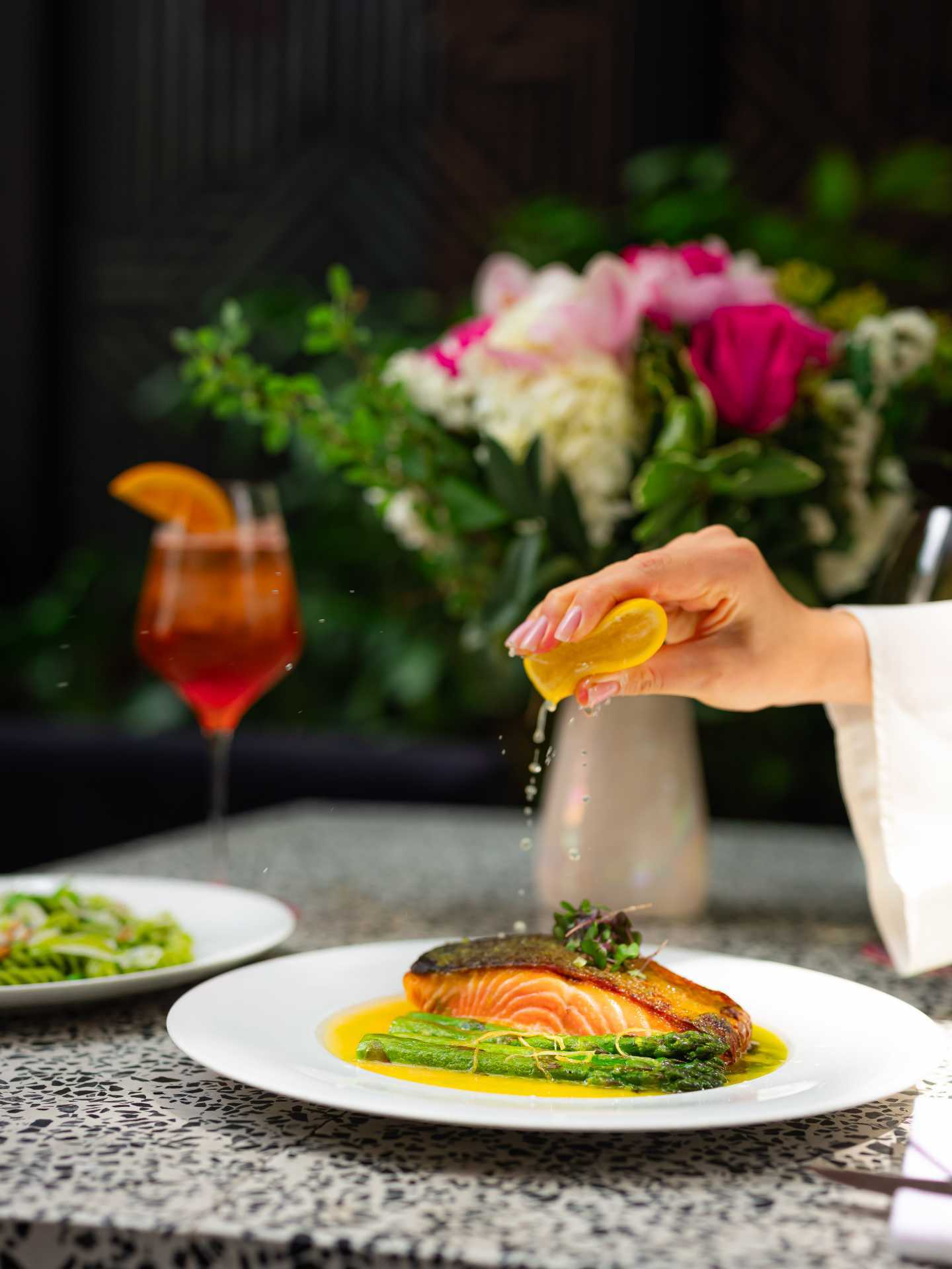 Italian restaurants Toronto | Squeezing a lemon over salmon at Sofia in Yorkville