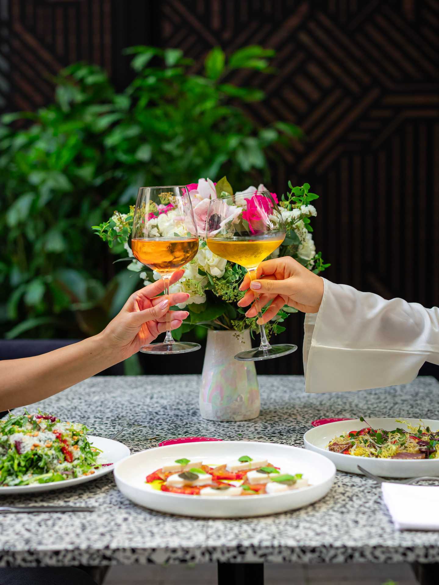 Italian restaurants Toronto | Two people cheers wine glasses at Sofia Italian Restaurant Toronto