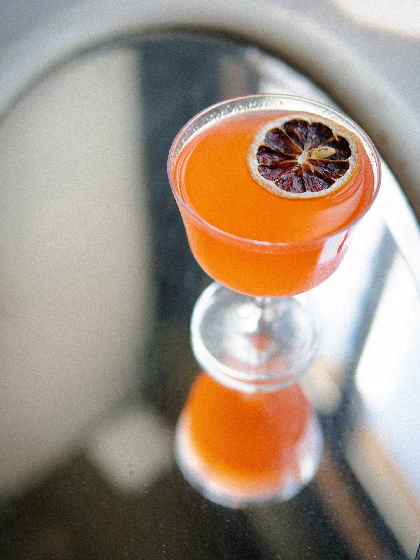 Italian restaurants Toronto | A bright orange cocktail in a coupe glass at GIA Italian restaurant in Toronto