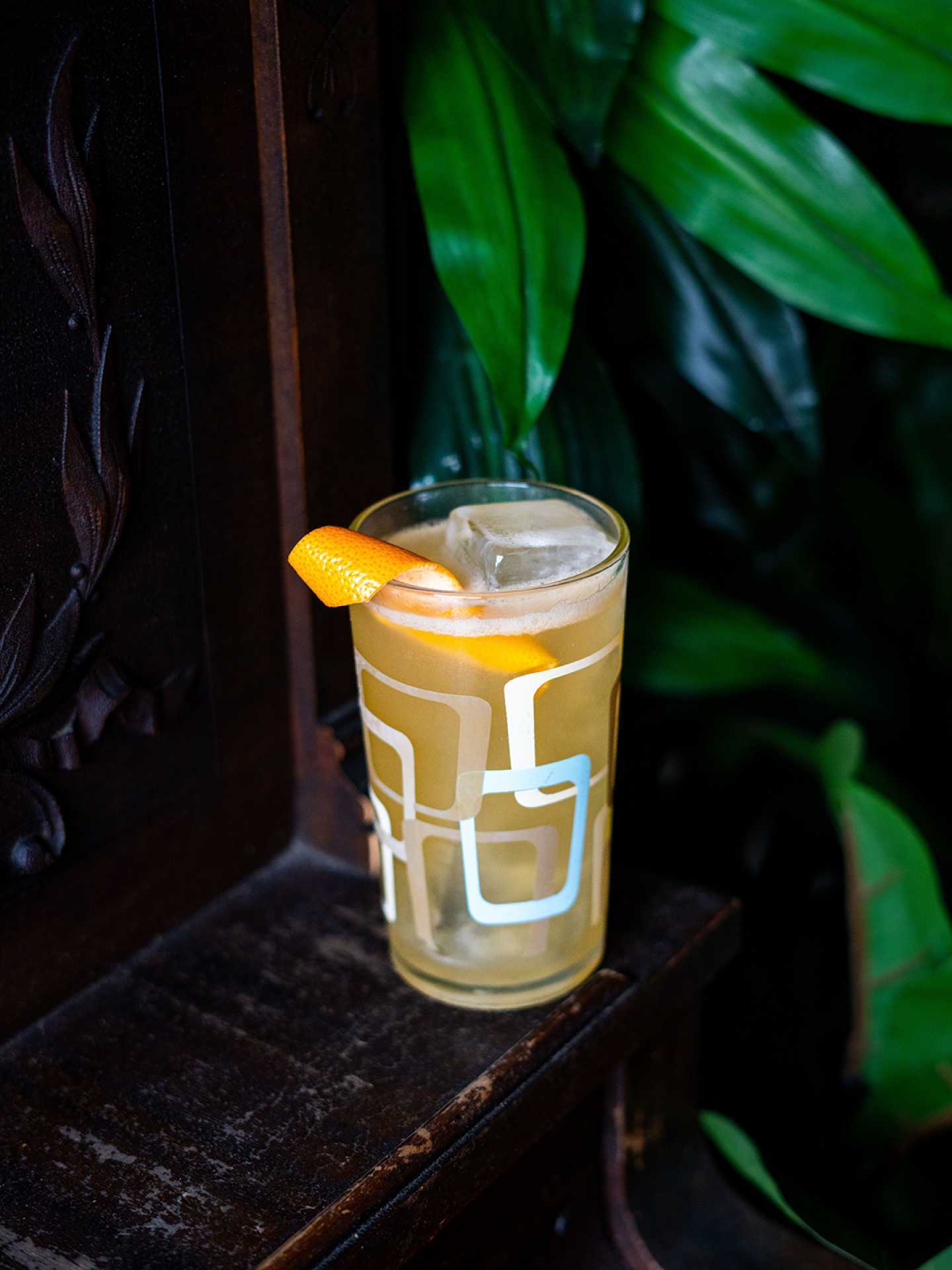 The best bars in Toronto | A yellow cocktail garnished with an orange peel at Civil Liberties